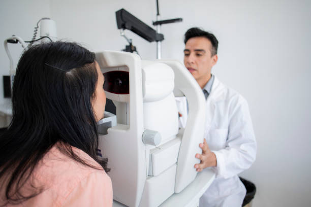 istock oculist examining female patient 1413438765