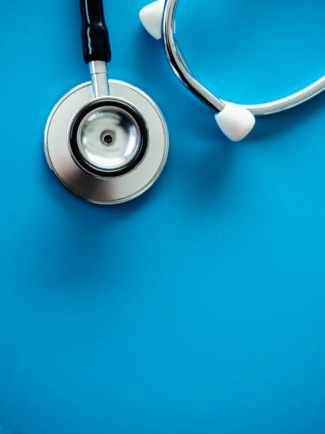 istock Close up stethoscope isolated on blue background with copy space, top view, vertical style. Healthcare and medical concept. 1413438783