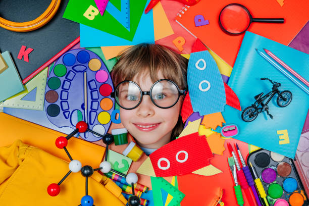 istock Funny girls face surrounded by different school stationery 1413439523