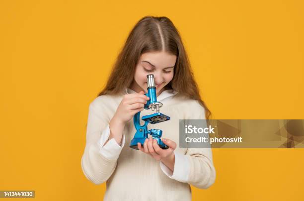Glad Child With Microscope On Yellow Background Stock Photo - Download Image Now - Back to School, Biological Cell, Biological Process