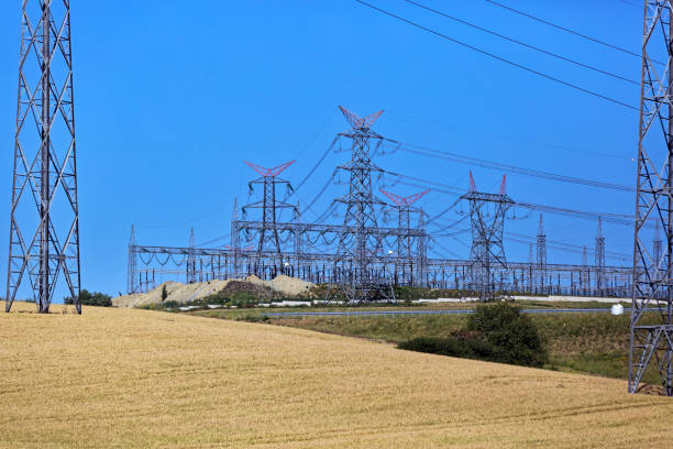 Power lines and pylon electricity pols along with crop fields in the rural area. Tekirdag, Turkey.