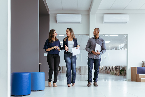 Coworkers talking and walking in the office