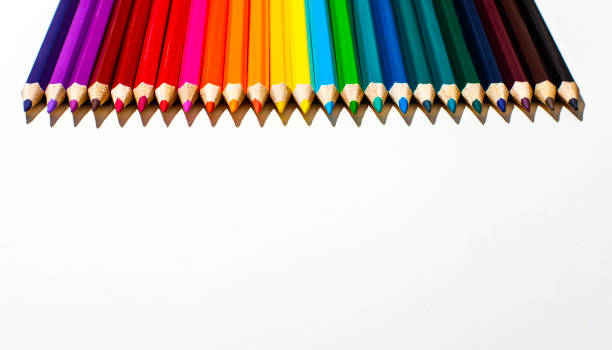istock Multi-colored wooden pencils on a white background close-up. Top view with copy space. Stationery 1413442889