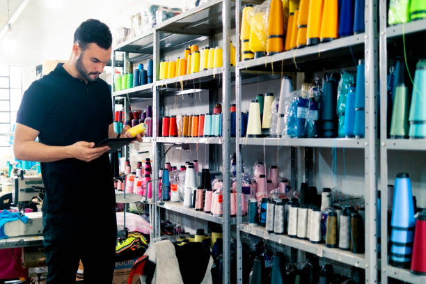 istock Young man in a clothes industry 1413443736