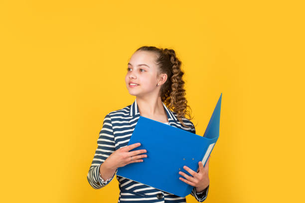 istock Administrative. Coordinator and project management. Library assistant. Student teen formal style. Education concept. Happy girl hold library folder. School library. Knowledge and information 1413444442