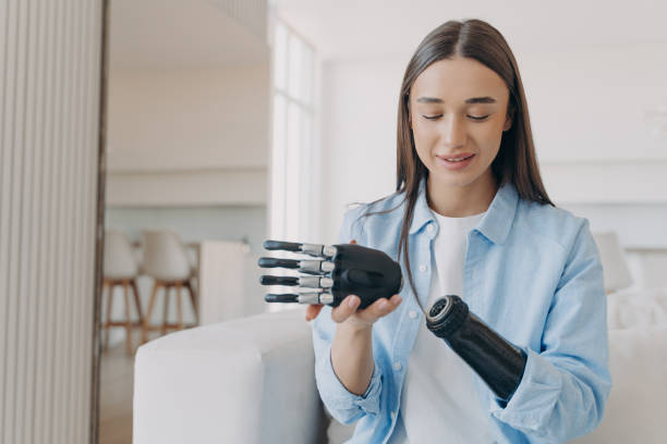 istock Disabled young woman is assembling bionic arm with hand. Prosthesis is connecting in wrist joint. 1413445643