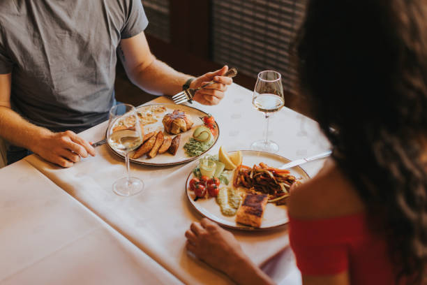 istock Young couple having lunch with white wine in the restaurant 1413445985