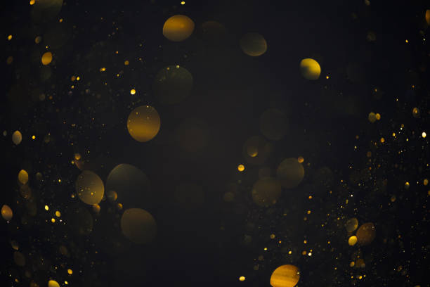 istock Gold glitter bokeh shiny dust particles lights 1413447098