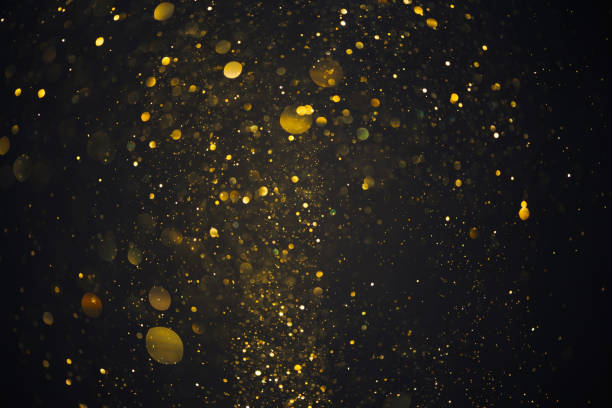 istock Gold glitter particles lights abstract dark background 1413447115