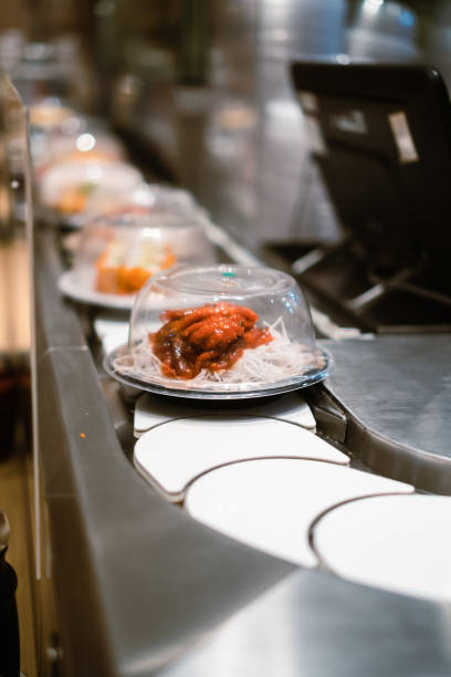 baby octopus on sushi belt or sushi conveyor - buffet japanese cuisine lifestyles ready to eat imagens e fotografias de stock