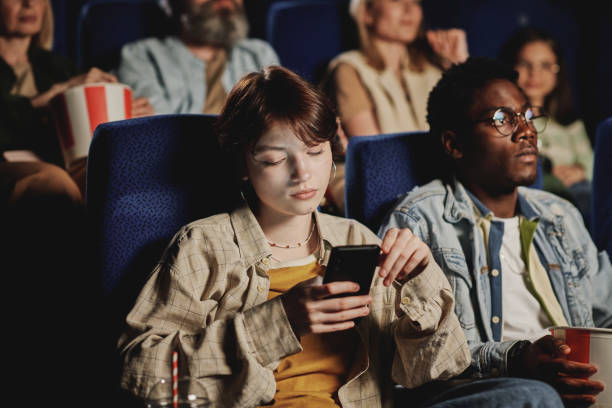 istock Chatting in Messenger at Cinema 1413450816