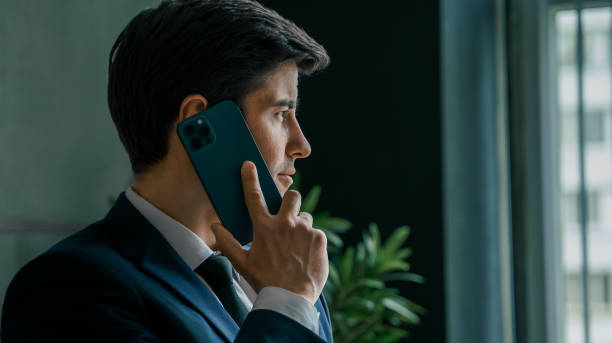 istock Businessman in suit with mobile phone in hands. Man typing message, using social net. Checking news. Making business meeting. Modern office.General manager,ceo.Calling to partner.Planning working day 1413450974