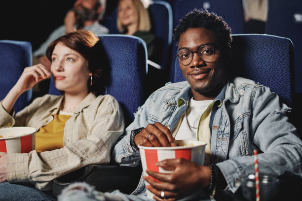 istock Young Black Guy Enjoying Date At Cinema 1413452218