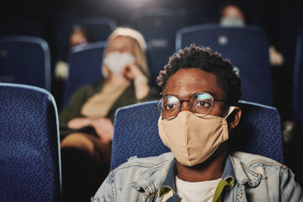 istock Black Man In Mask At Cinema 1413452525