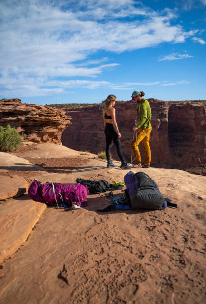 istock Young couple setting the lines for rope walking near Moab park 1413453781