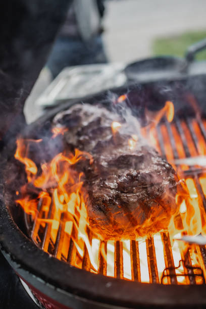 istock Cooking steak over fire grill 1413456163