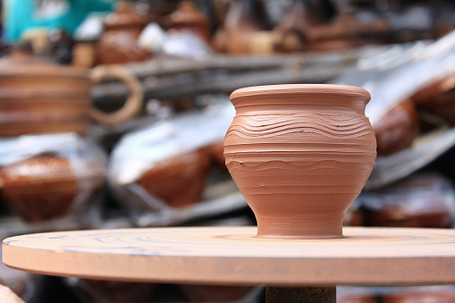 Clay pot close-up during its manufacture on potter's wheel