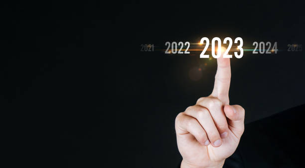 istock 2023. businessman hand touching and pointing on year 2023 with virtual screen on dark background, goal target, change from 2022 to 2023, strategy, investment, business planning, happy new year concept 1413456609