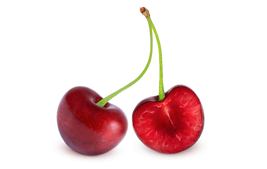 Cherry on an isolated white background. Whole and half cherries.