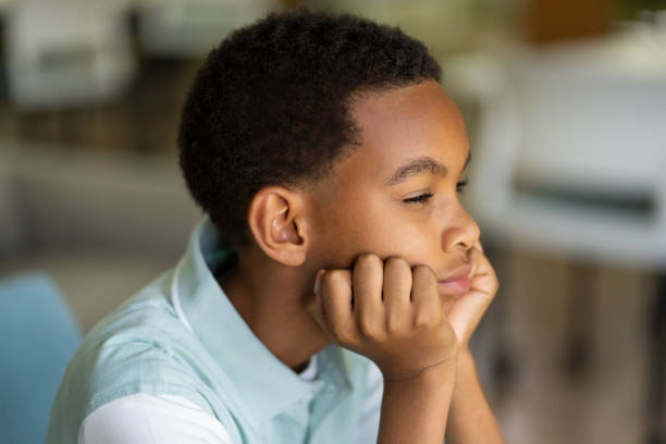 istock Little boy looking away and thinking 1413457782