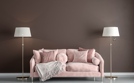 Glamour elegant living room with rose / light pink velvet sofa, decoration on gray tiled floor in front of empty chocolate brown plaster wall with copy space, and two elegant lamps on both sides of the sofa. Slight vintage effect added. 3D rendered image.