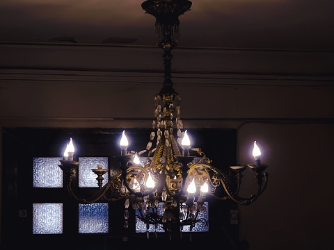 Burning chandelier indoors close up