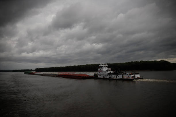 tow boat and barges on Mississippi river during thunderstorm