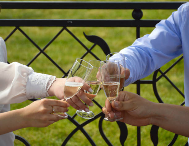 istock hands with glasses of champagne stretch for congratulations on the wedding 1413464721