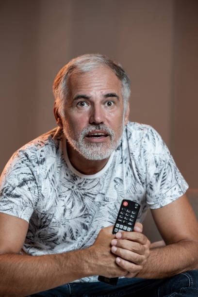 istock Mature man watching TV 1413464844