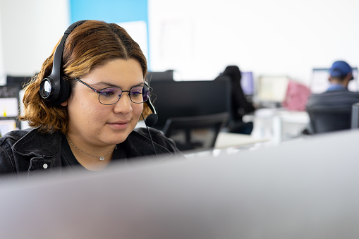 Beauty woman working in a callcenter using a black clothes.