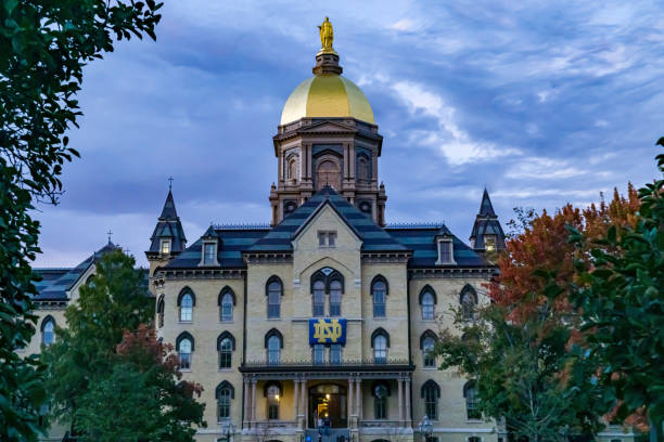 Notre Dame at Dusk Golden Dome on the Main Building at the University of Notre Dame at Dusk south bend stock pictures, royalty-free photos & images