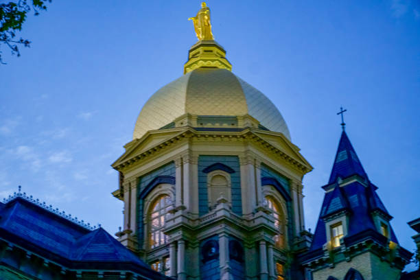 Notre Dame at Dusk Golden Dome on the Main Building at the University of Notre Dame at Dusk south bend stock pictures, royalty-free photos & images