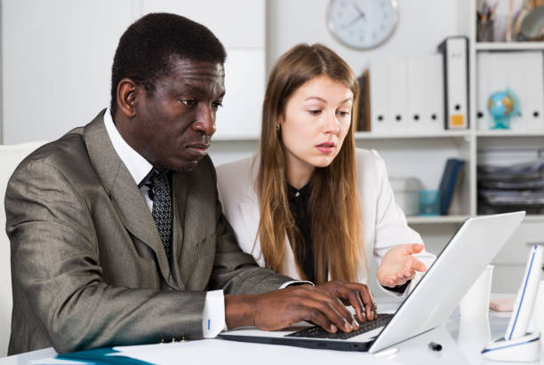 istock Focused coworkers working together 1413470907