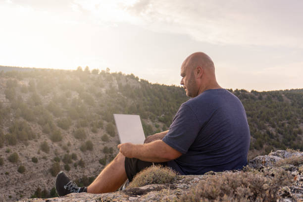 istock digital nomad walking nature laptop 1413471283