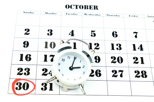 Clock marking winter time change over october calendar