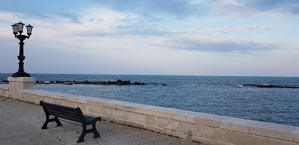 Beautiful seaview in Bari, Italy. Calm evening, blue water colors, light clouds on the sky. Beautiful nature.
