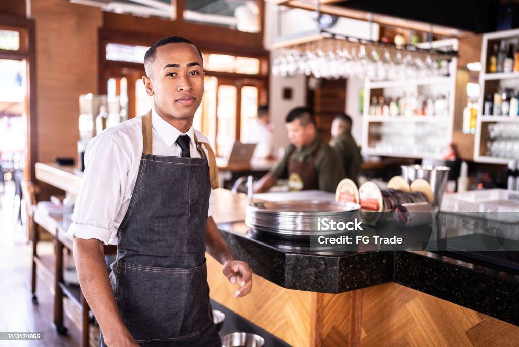 Portrait of a waiter at a restaurant Small Business Stock Photo