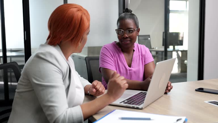 Over shoulder view African corporate manager meeting with female broker