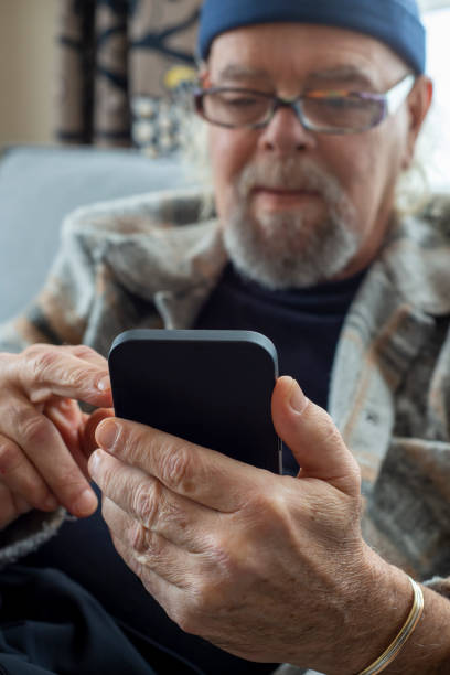 istock Old man communicating by mobile phone 1413476752