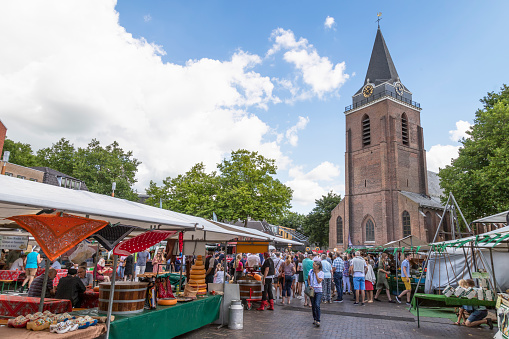 Woerden, Netherlands, August 6, 2022; Regional market on the church square in Woerden with the Peter's Church in the background.