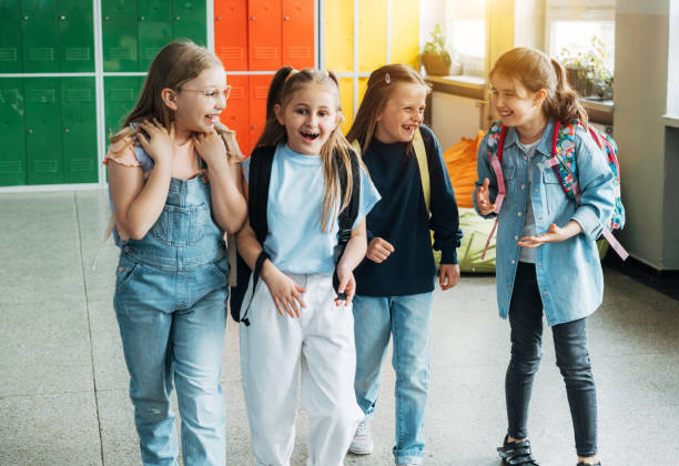 istock Group of elementary school girls walking in corridor 1413479103