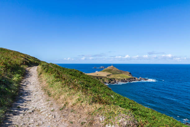 istock Cape Cornwall viewed from the coast path above, with a blue sky overhead 1413479254
