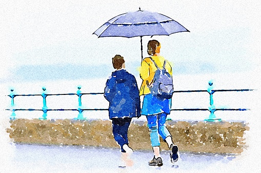 Mother and daughter with umbrella during British wet summer UK