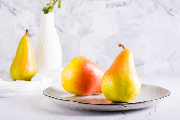 istock Ripe pears on a plate on the table. Autumn fruits. 1413481694