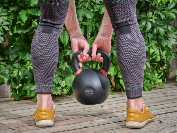 istock male is exercising with a heavy iron kettlebell 1413482867