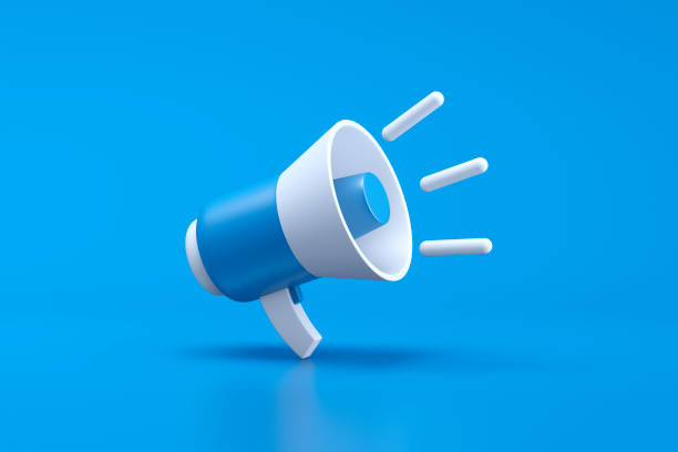 Single blue and white electric megaphone with a handle stands on a blue background stock photo
