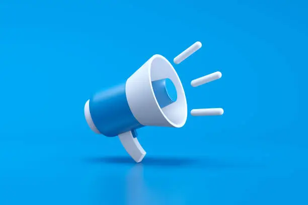 Photo of Single blue and white electric megaphone with a handle stands on a blue background