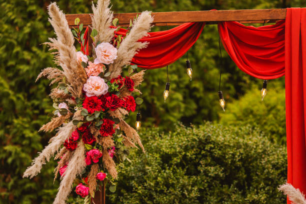 istock Wedding arch in boho style with flowers and light bulbs. Autumn wedding ceremony. Decor. Rustic 1413483255