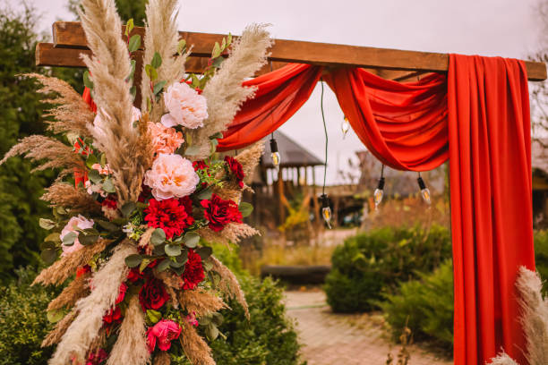 istock Wedding arch in boho style with flowers and light bulbs. Autumn wedding ceremony. Decor. Rustic 1413483329