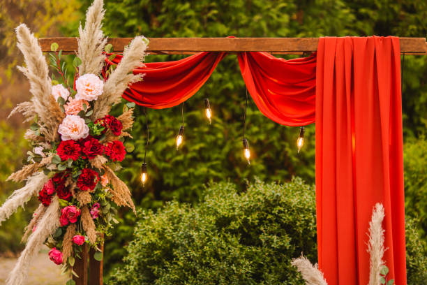 istock Wedding arch in boho style with flowers and light bulbs. Autumn wedding ceremony. Decor. Rustic 1413483386